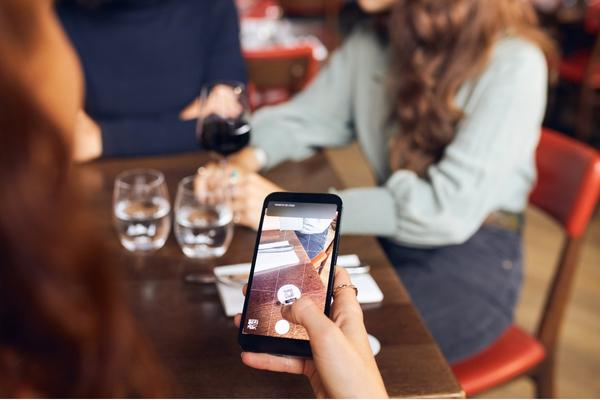 person using qr ordering app at hospitality function