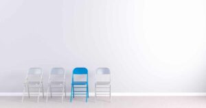 blue chair standing out from white chairs